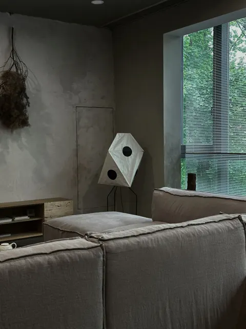 Contemporary living room with textured gray walls and floor-to-ceiling windows
